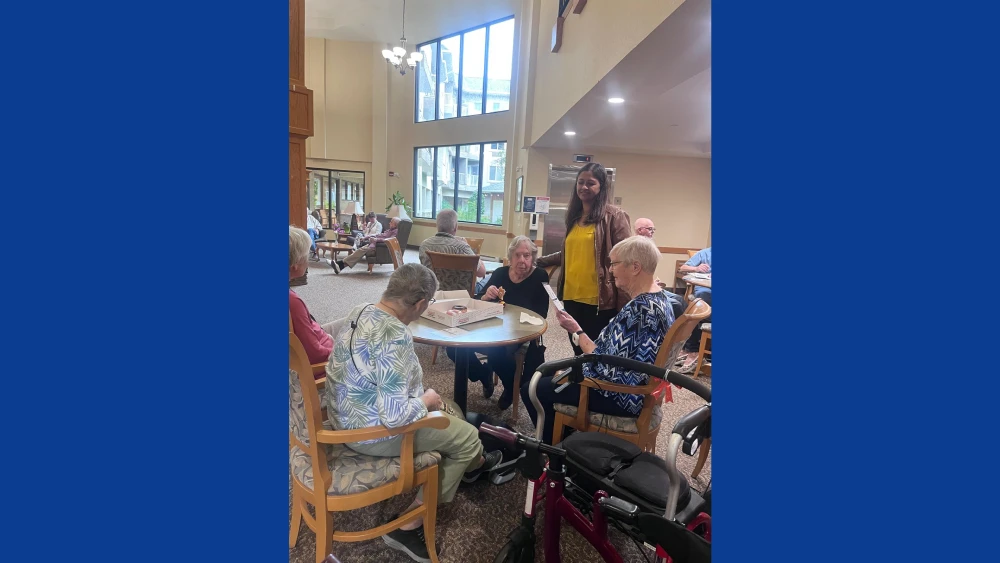 anita-roy-listening-to-seniors-st-norbert-seine-river