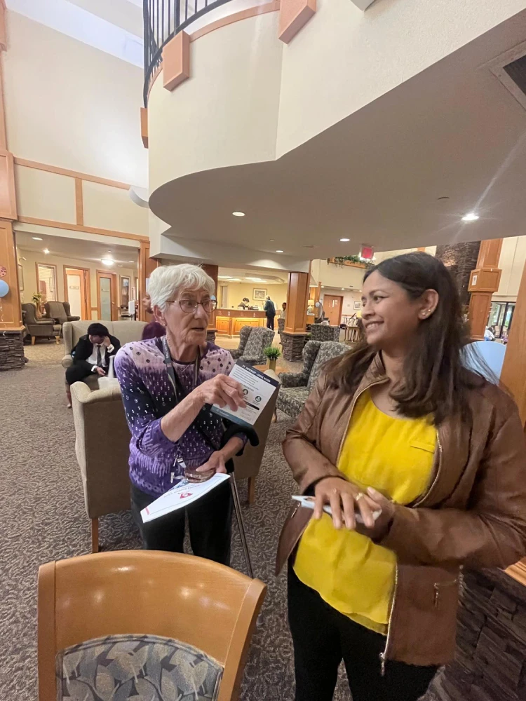 anita-roy-listening-to-seniors-st-norbert-seine-river