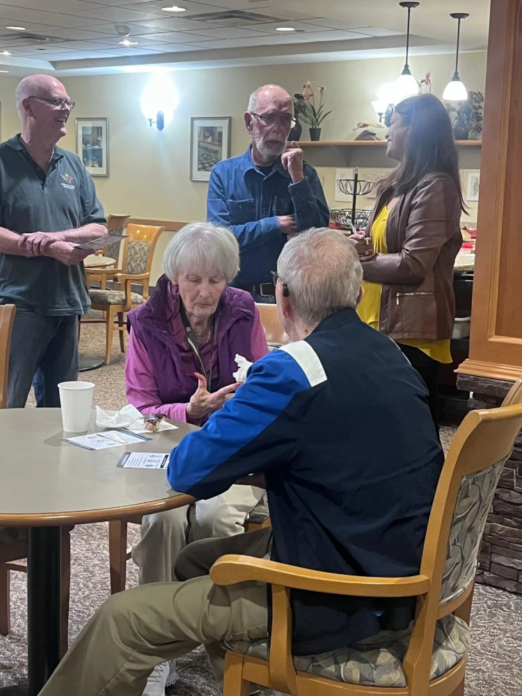 anita-roy-listening-to-seniors-st-norbert-seine-river